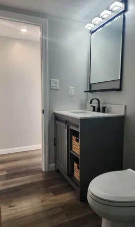 a bathroom with a toilet sink and mirror