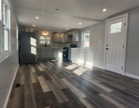 a kitchen with stainless steel appliances kitchen island granite countertop a refrigerator and a stove top oven