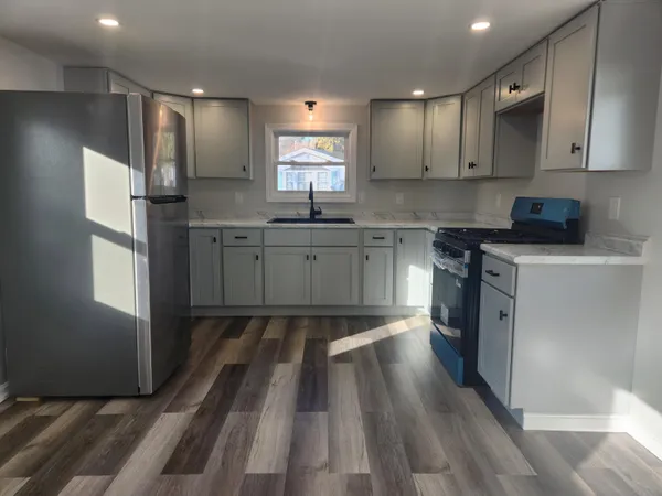 a kitchen with a sink stove and refrigerator