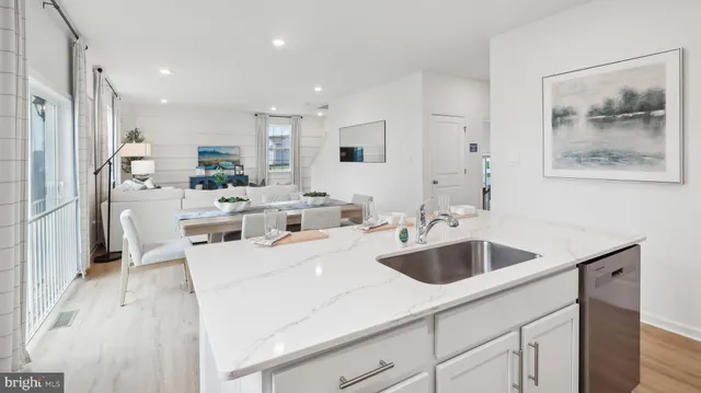 a large white kitchen with a large window
