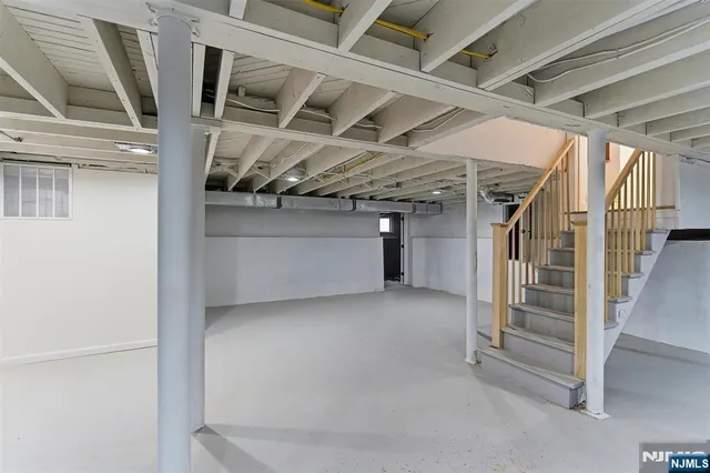 a view of an empty room with a staircase