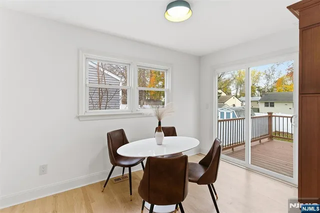 a dining room with furniture a chandelier and wooden floor