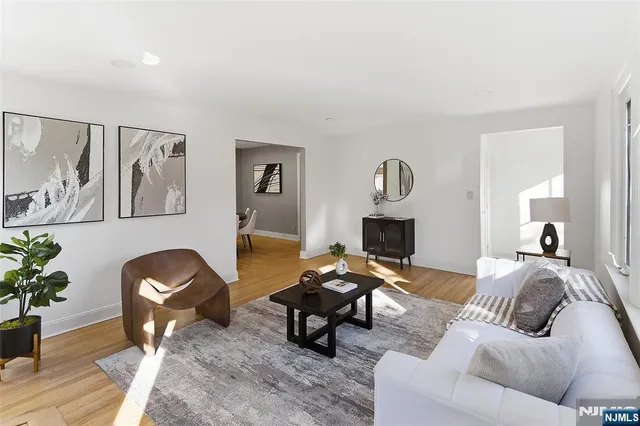 a living room with furniture a fireplace and potted plants