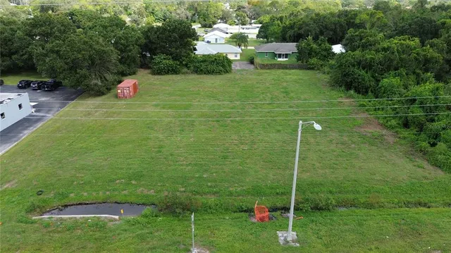 a view of a lush green forest with a house