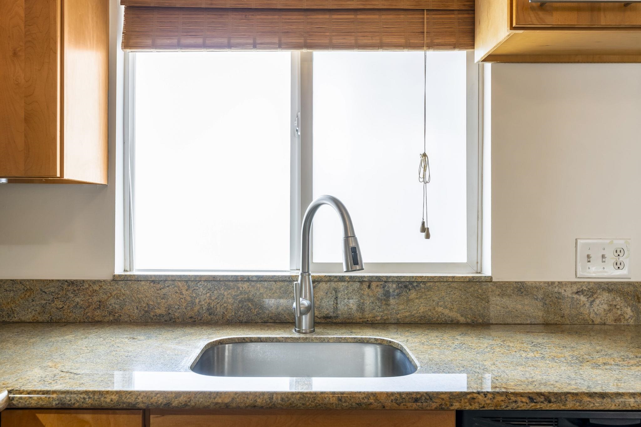 2670 Kanakanui Road Kihei, HI 96753 - Photo 11 of 41 a kitchen with a sink and a window
