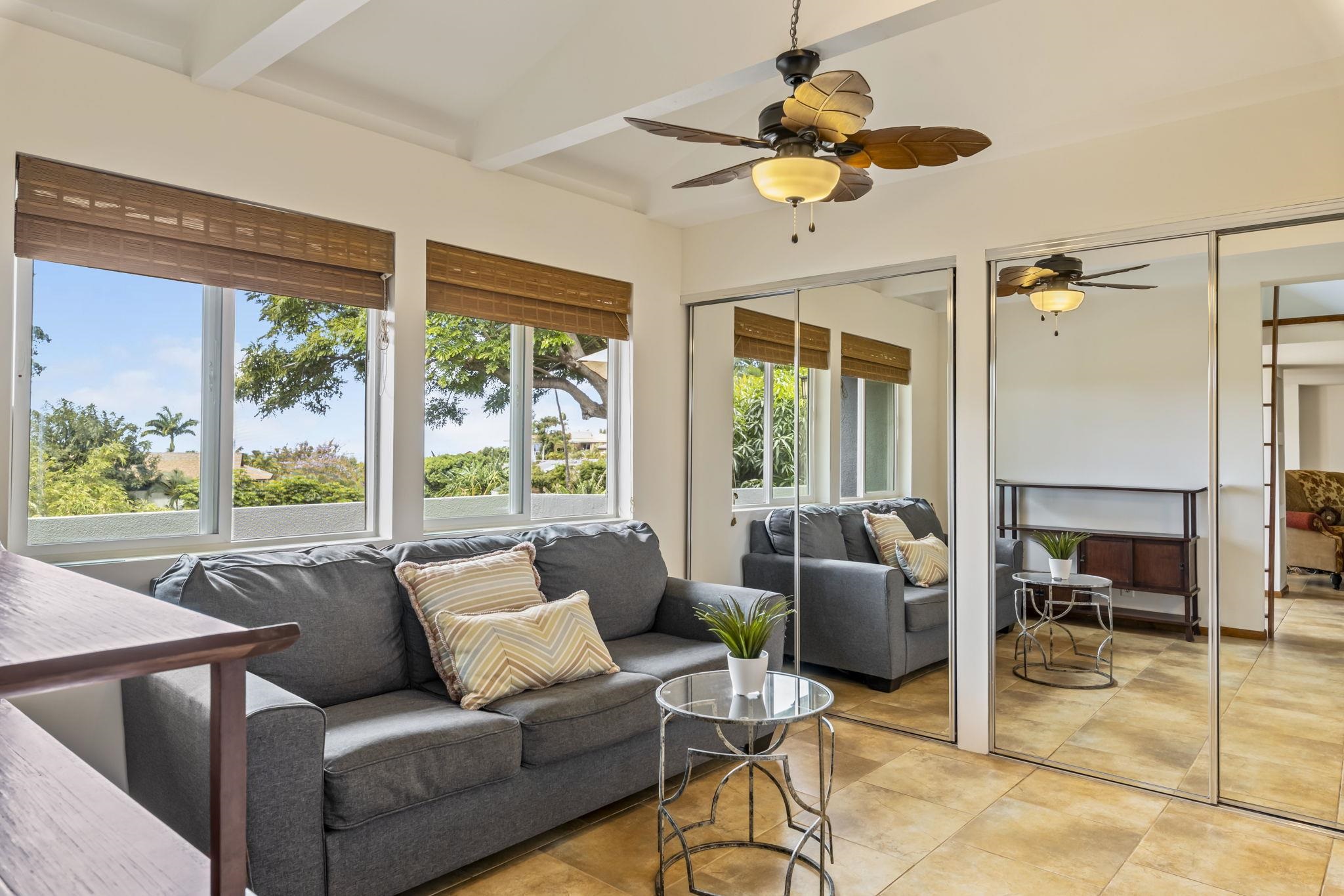 2670 Kanakanui Road Kihei, HI 96753 - Photo 12 of 41 a living room with furniture and a large window