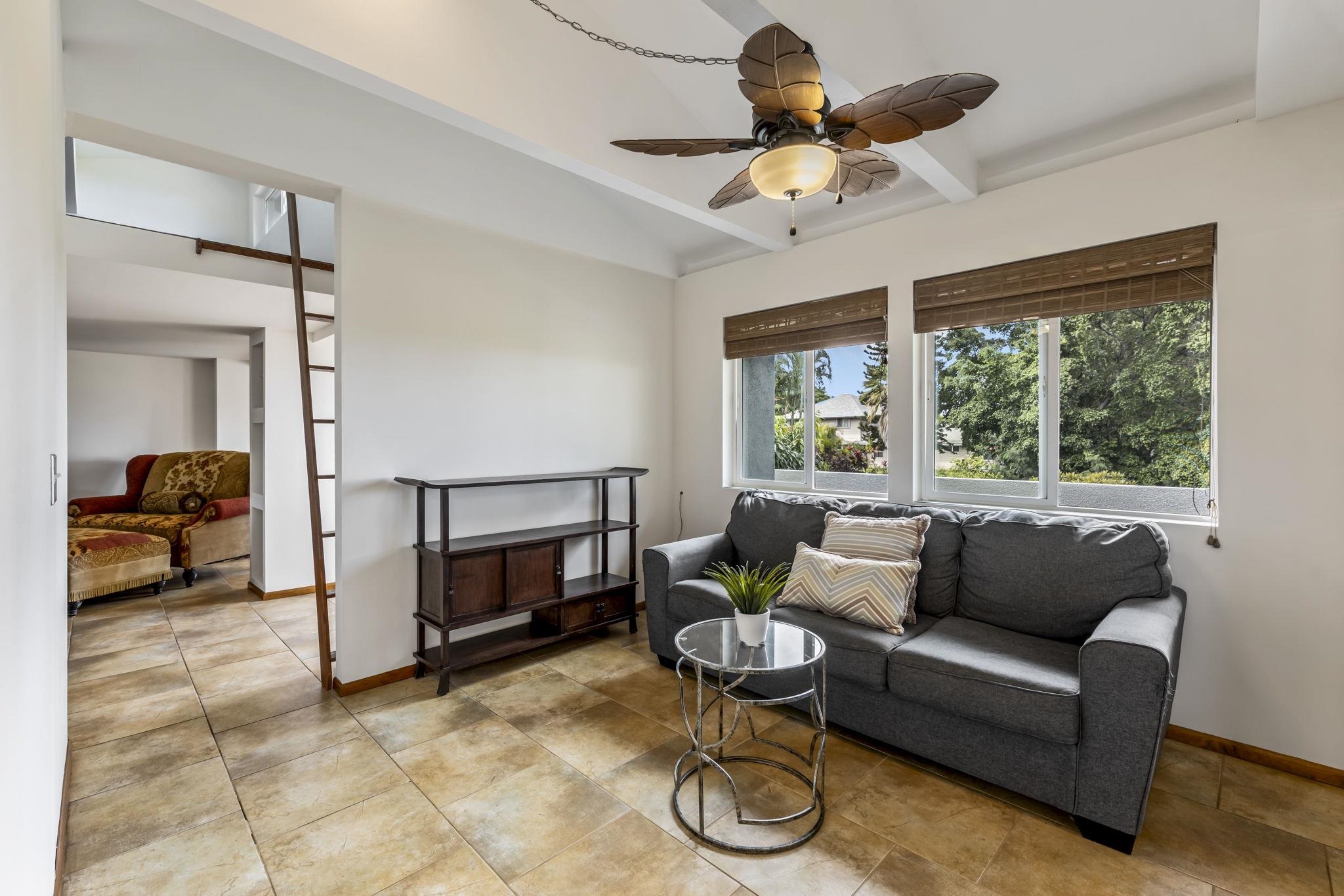 2670 Kanakanui Road Kihei, HI 96753 - Photo 13 of 41 a living room with furniture and a large window