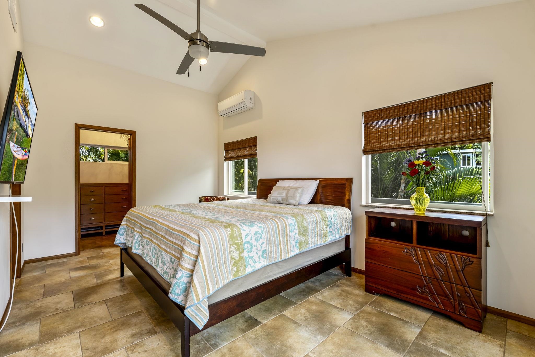 2670 Kanakanui Road Kihei, HI 96753 - Photo 15 of 41 a large bed sitting in a bedroom next to a window