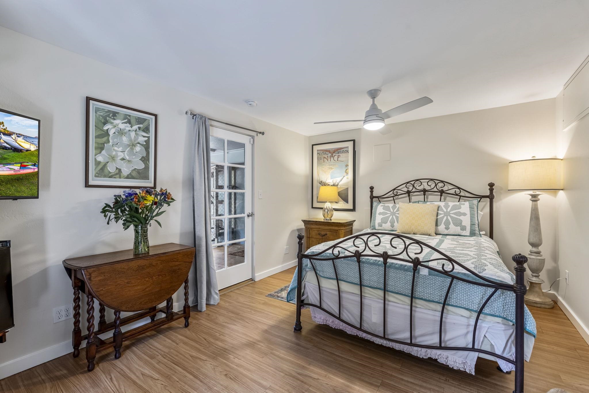2670 Kanakanui Road Kihei, HI 96753 - Photo 26 of 41 a bedroom with a bed a dresser and chair