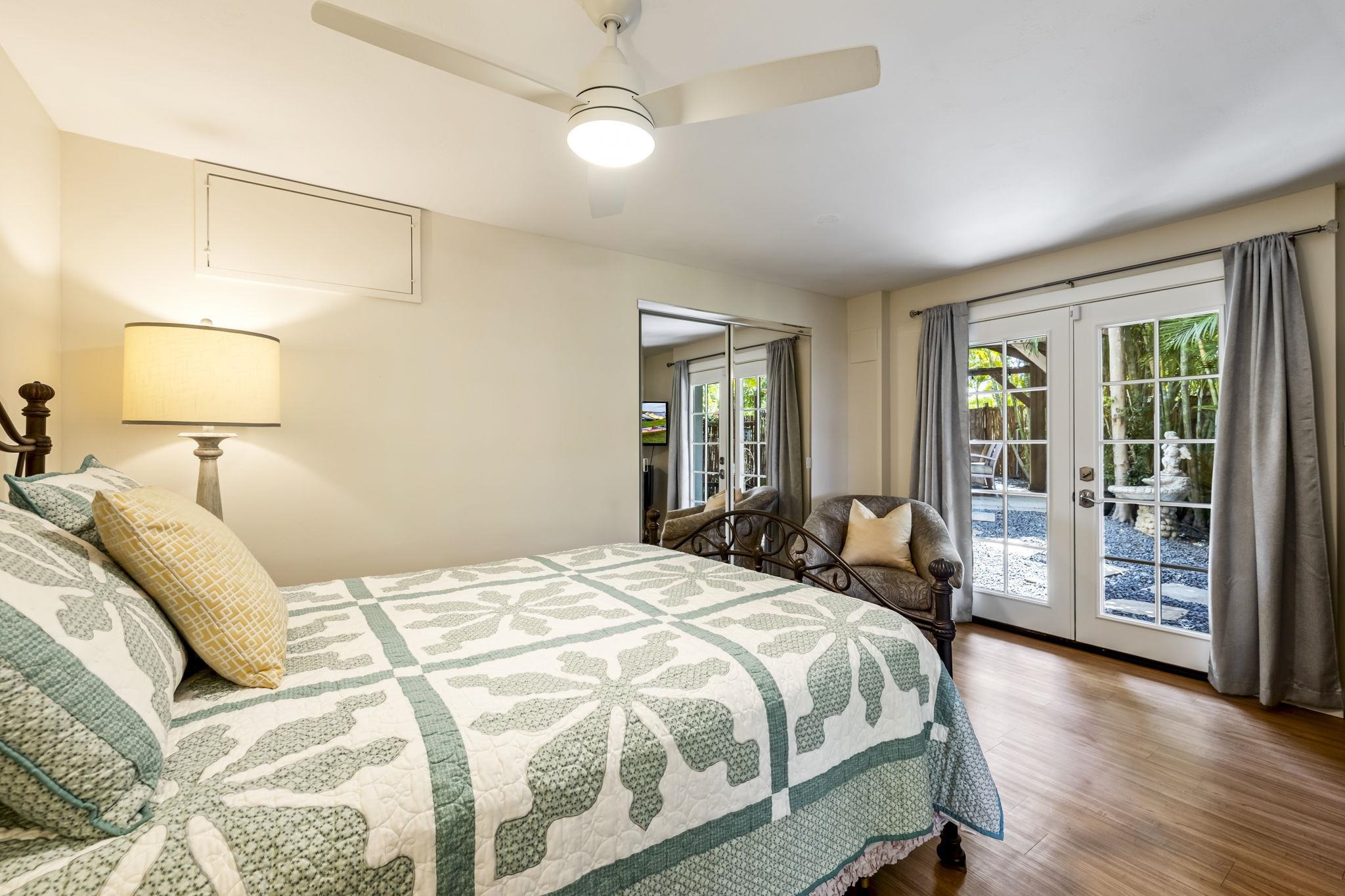 2670 Kanakanui Road Kihei, HI 96753 - Photo 33 of 41 a bedroom with a large bed and wooden floor