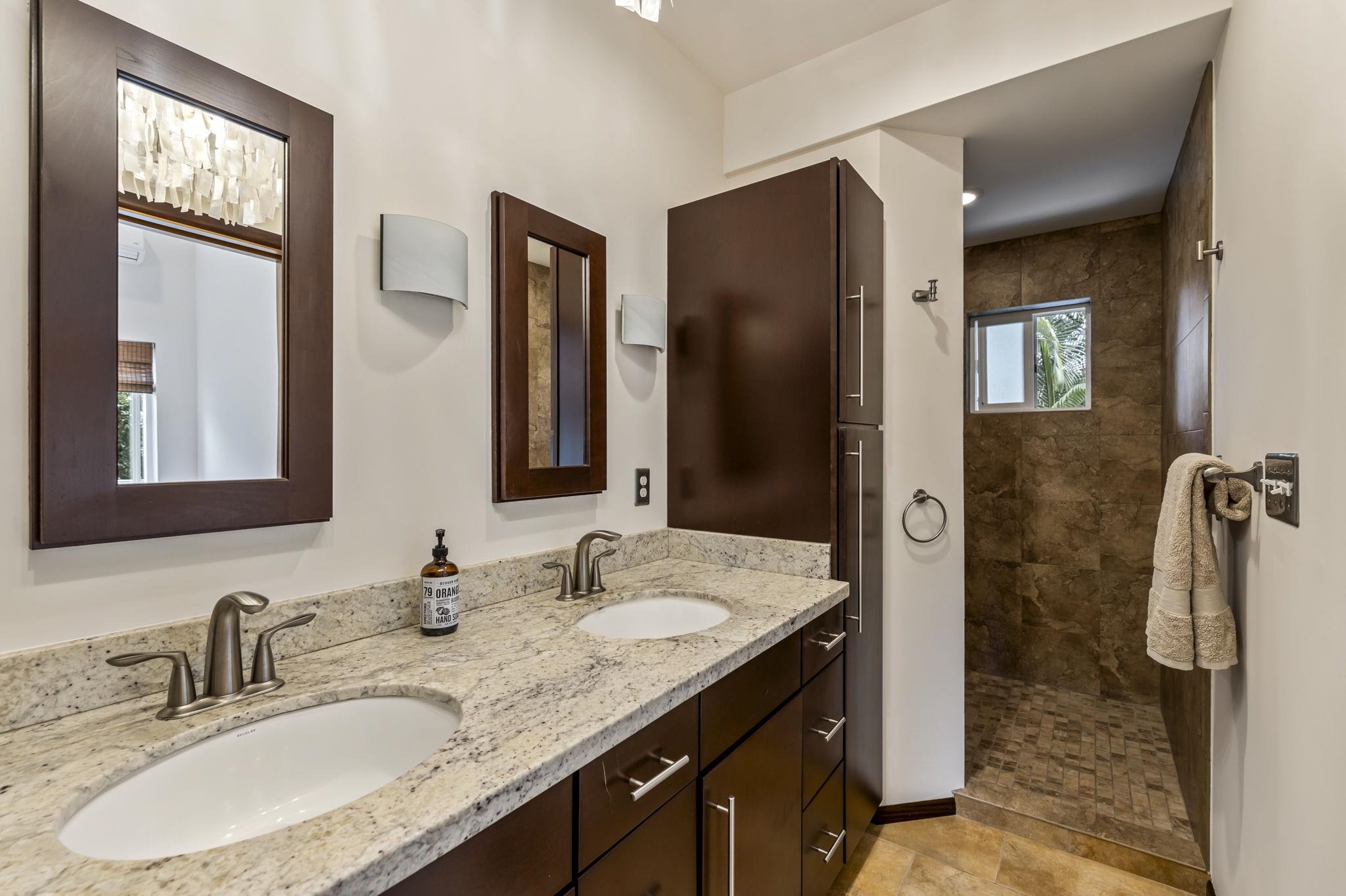 2670 Kanakanui Road Kihei, HI 96753 - Photo 38 of 41 a bathroom with a granite countertop sink and a mirror