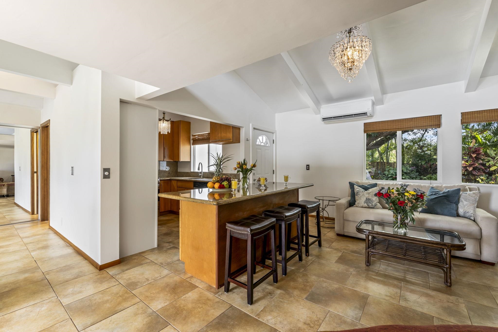 2670 Kanakanui Road Kihei, HI 96753 - Photo 7 of 41 a living room with furniture a dining table and a piano table