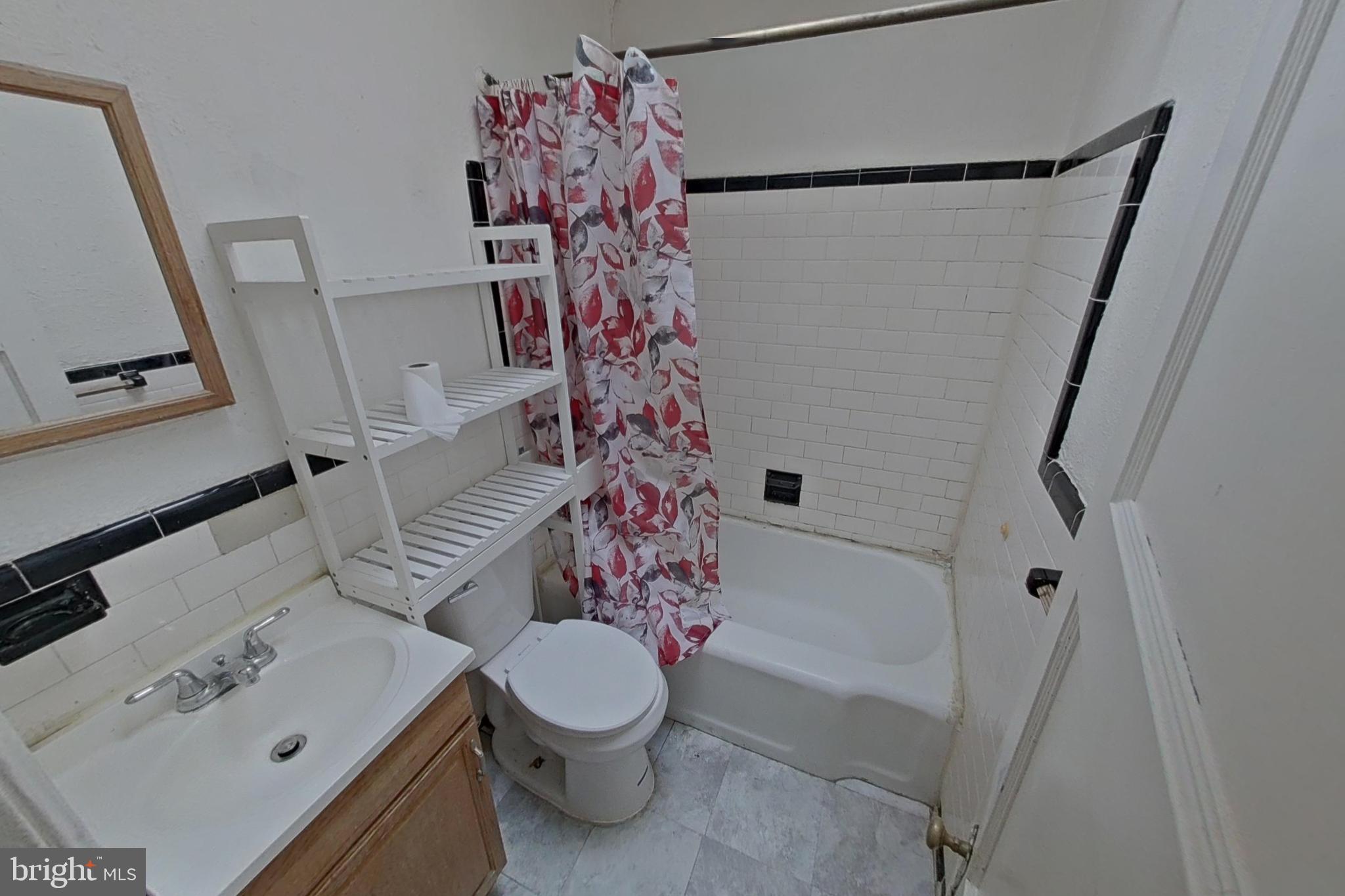 3716 Flowerton Road Baltimore, MD 21229 - Photo 11 of 21 a bathroom with a sink toilet and shower