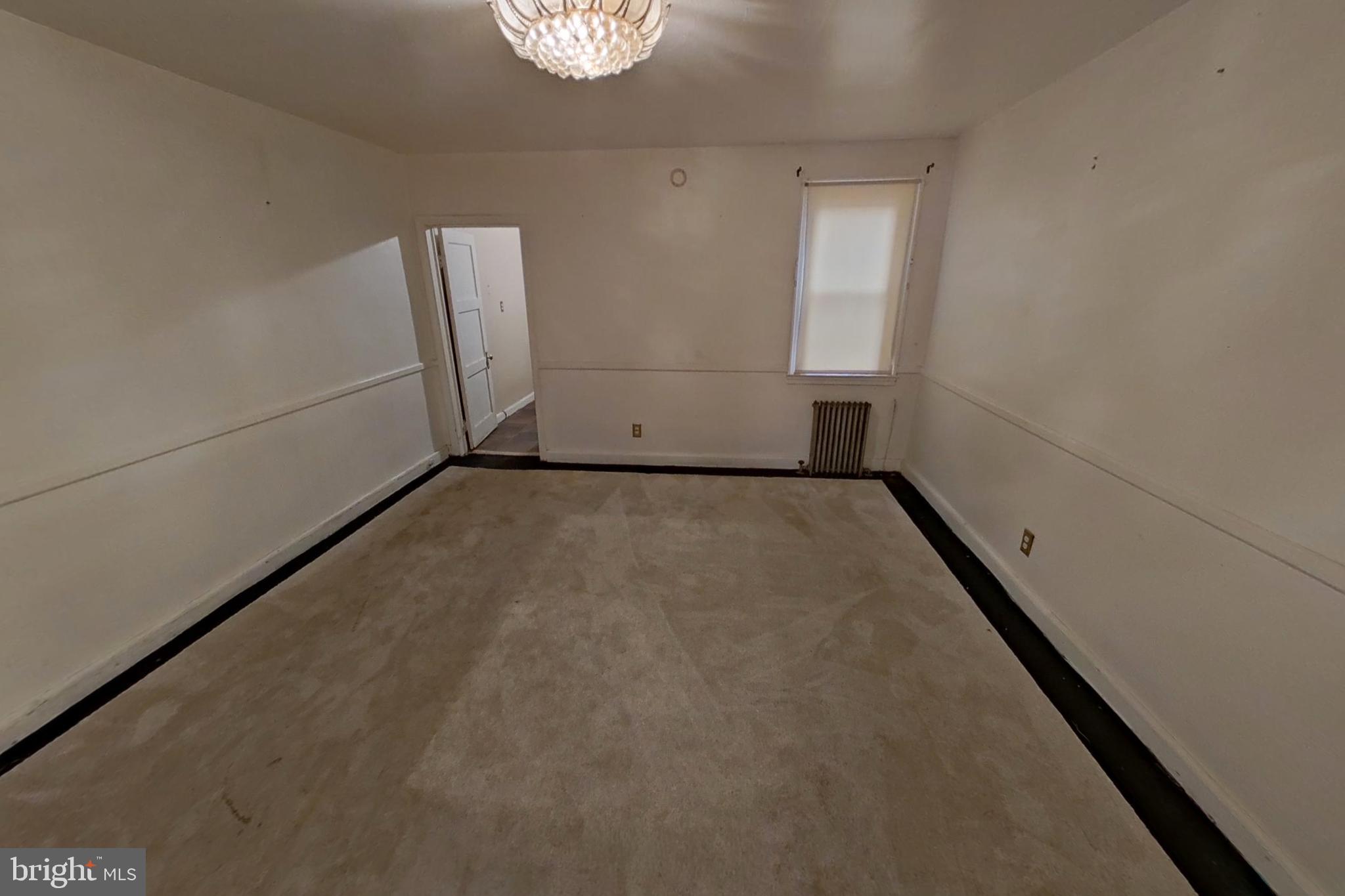 3716 Flowerton Road Baltimore, MD 21229 - Photo 6 of 21 an empty room with a empty space and windows