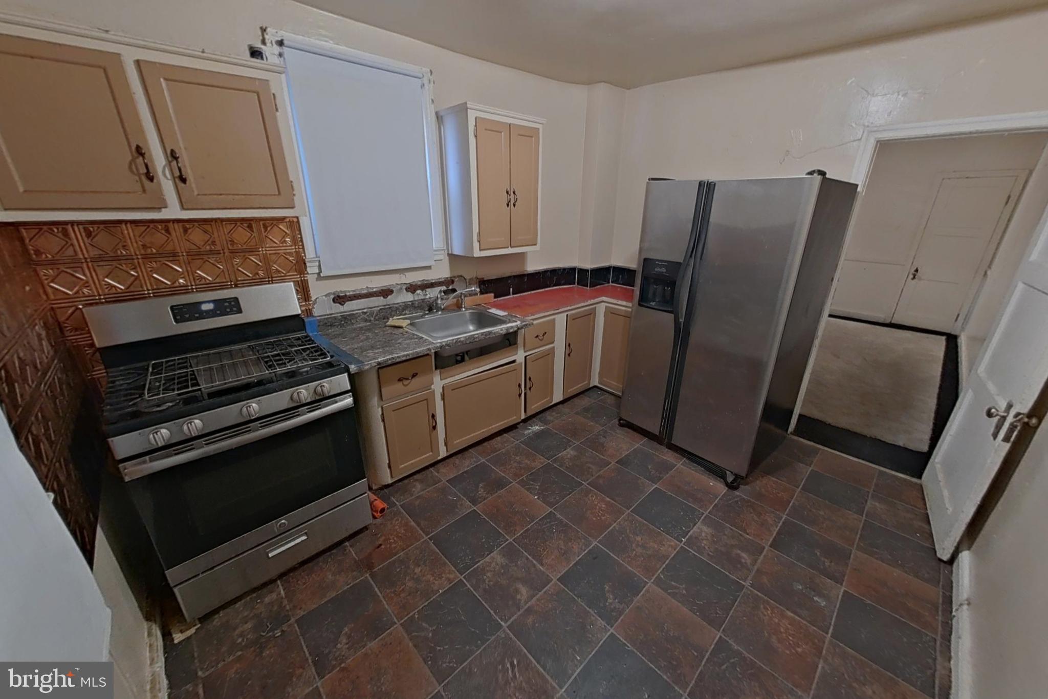 3716 Flowerton Road Baltimore, MD 21229 - Photo 8 of 21 a kitchen with a stove microwave and refrigerator