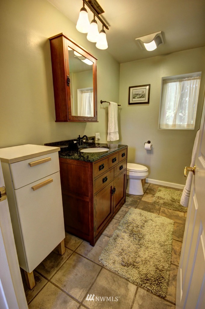 6294 Mission Road Bellingham, WA 98226 - Photo 15 of 25 a bathroom with a toilet sink and mirror