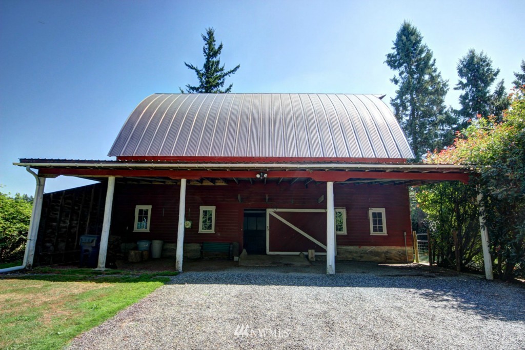 6294 Mission Road Bellingham, WA 98226 - Photo 19 of 25 a view of a house with a yard and floor to ceiling window