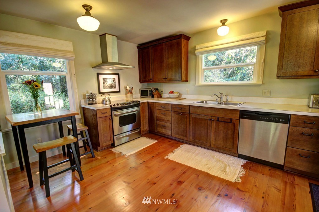6294 Mission Road Bellingham, WA 98226 - Photo 5 of 25 a kitchen with a sink stove and cabinets