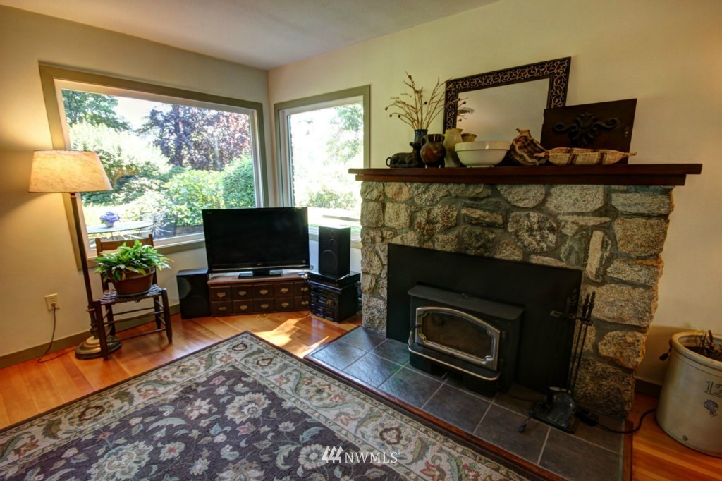 6294 Mission Road Bellingham, WA 98226 - Photo 7 of 25 a living room with furniture a flat screen tv and a fireplace