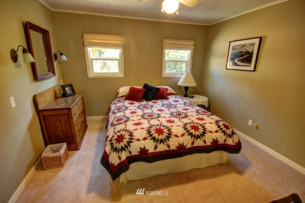 6294 Mission Road Bellingham, WA 98226 - Photo 9 of 25 a bedroom with a bed and wooden floor
