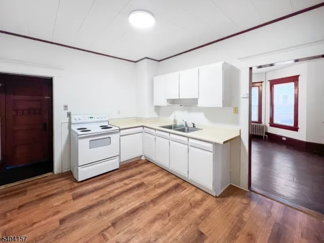 a kitchen with white cabinets and white appliances