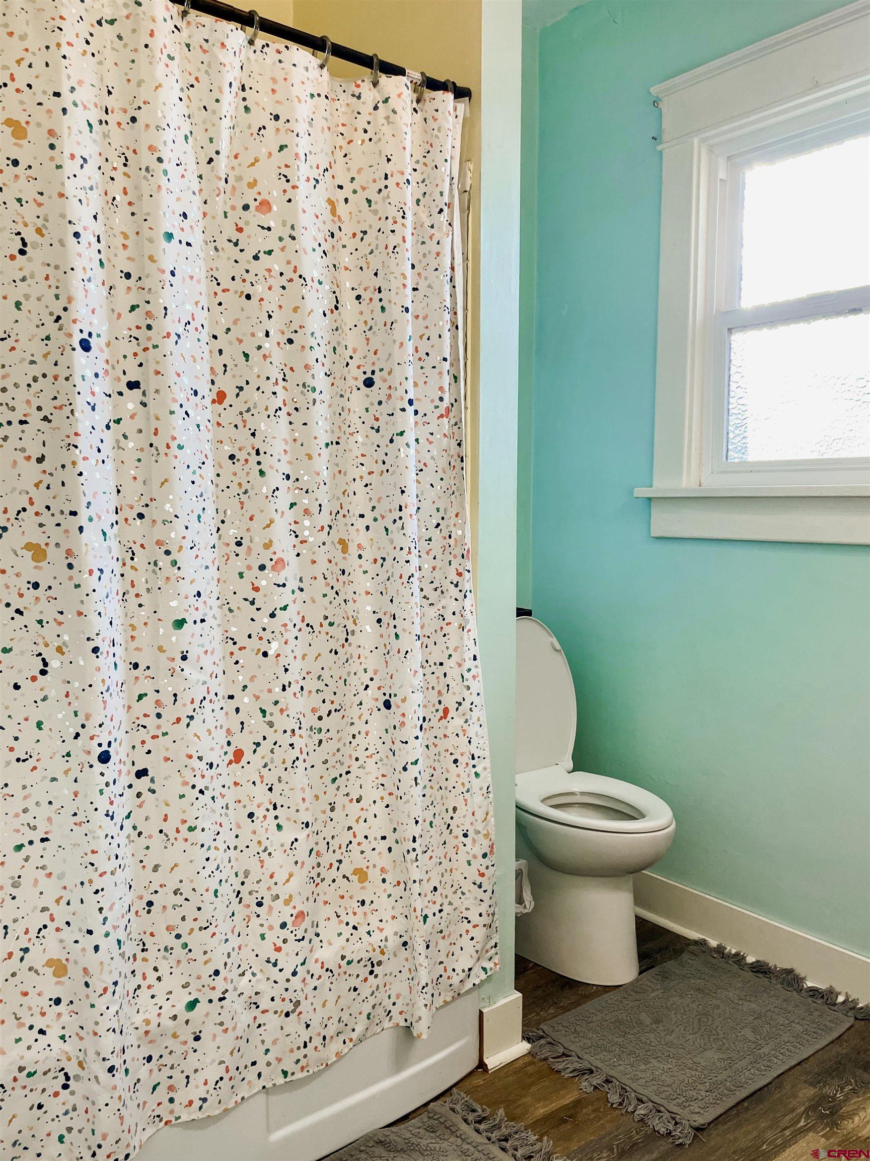 19643 H Road Delta, CO 81416 - Photo 20 of 35 a bathroom with a toilet and a shower curtain