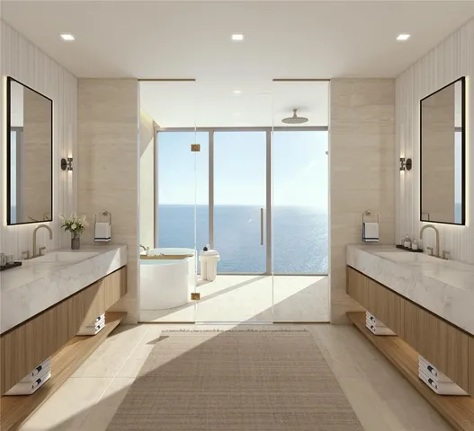 a bathroom with a tub a sink and a large mirror