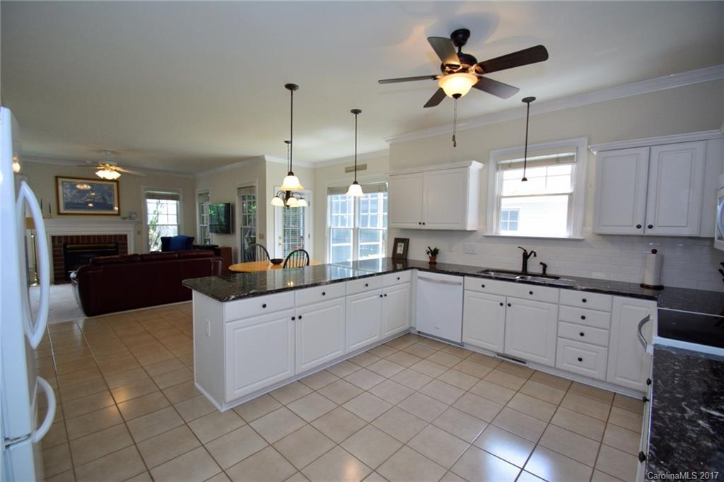 229 Kimberly Road Davidson, NC 28036 - Photo 4 of 23 a large white kitchen with a window and cabinets