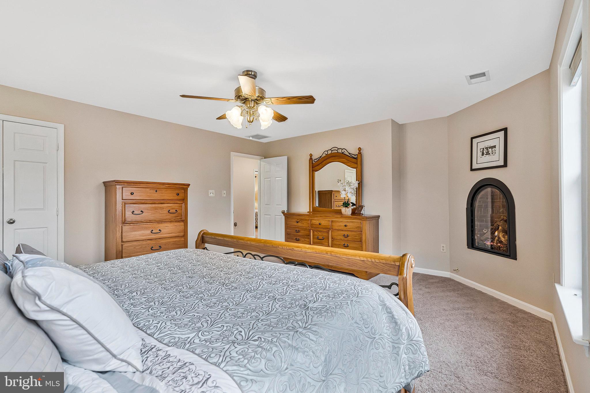 1545 Kingstream Circle Herndon, VA 20170 - Photo 25 of 71 a bedroom with a large bed and a chandelier