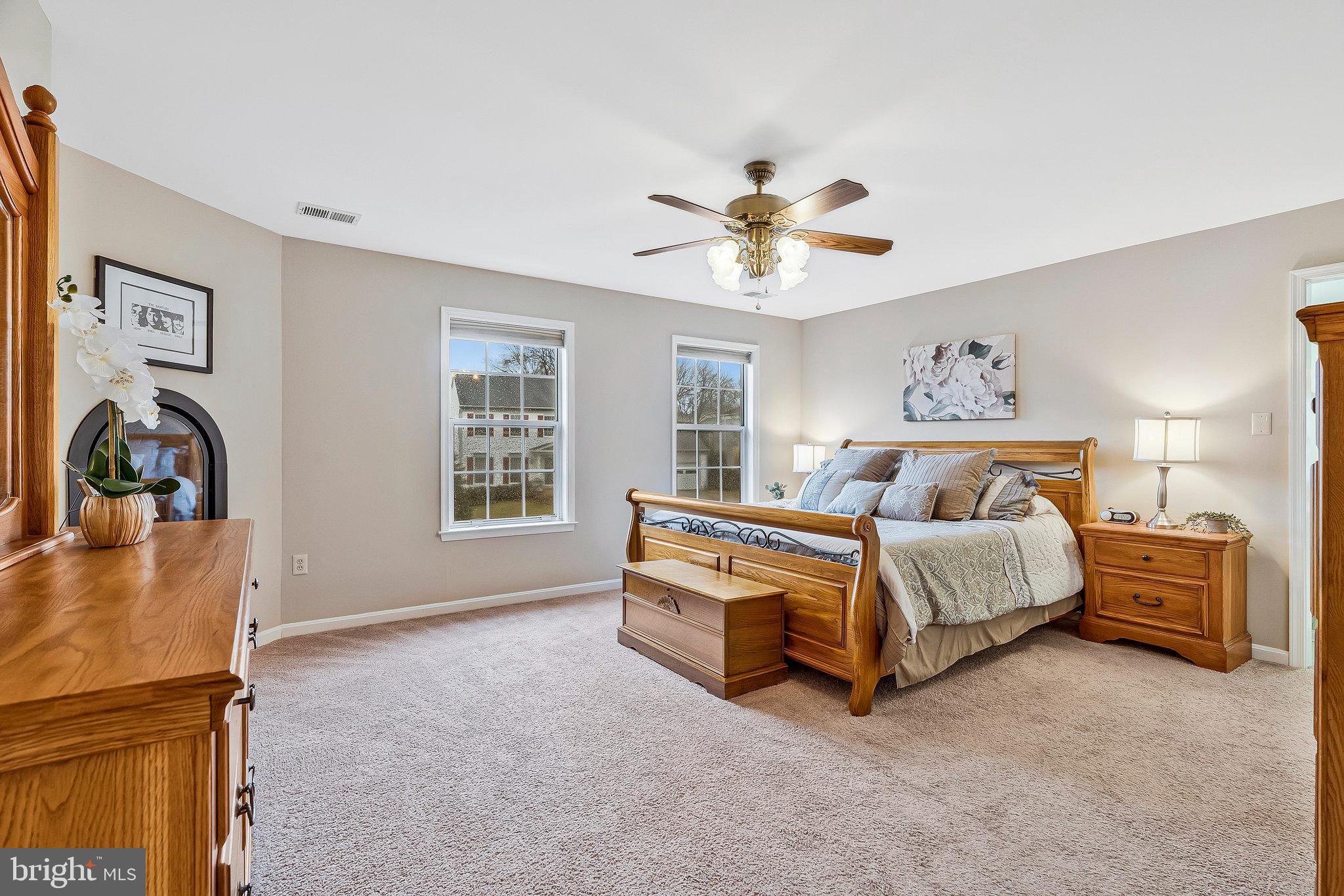 1545 Kingstream Circle Herndon, VA 20170 - Photo 26 of 71 a spacious bedroom with a bed and a chandelier