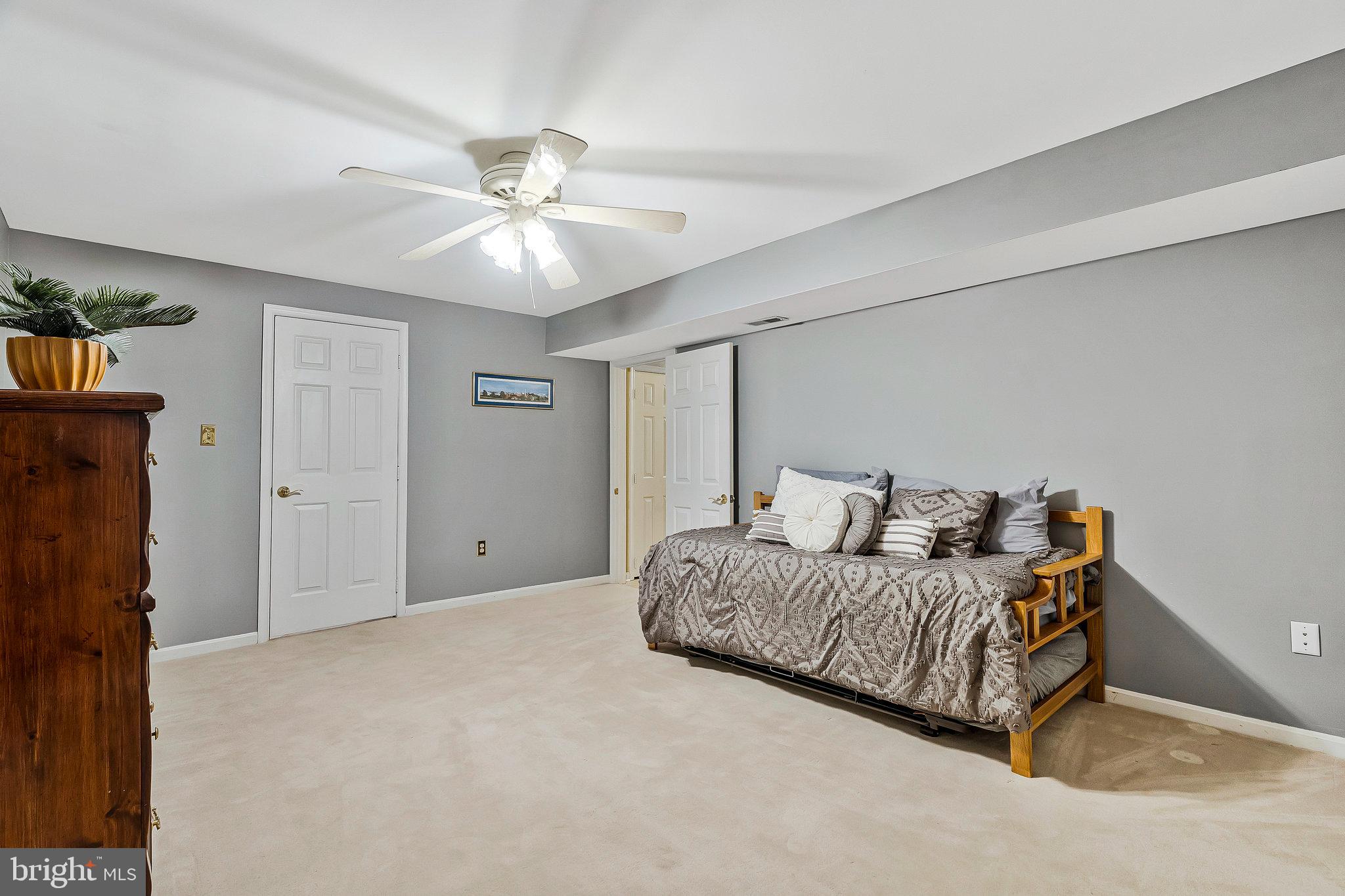 1545 Kingstream Circle Herndon, VA 20170 - Photo 49 of 71 a living room with a bed and a ceiling fan