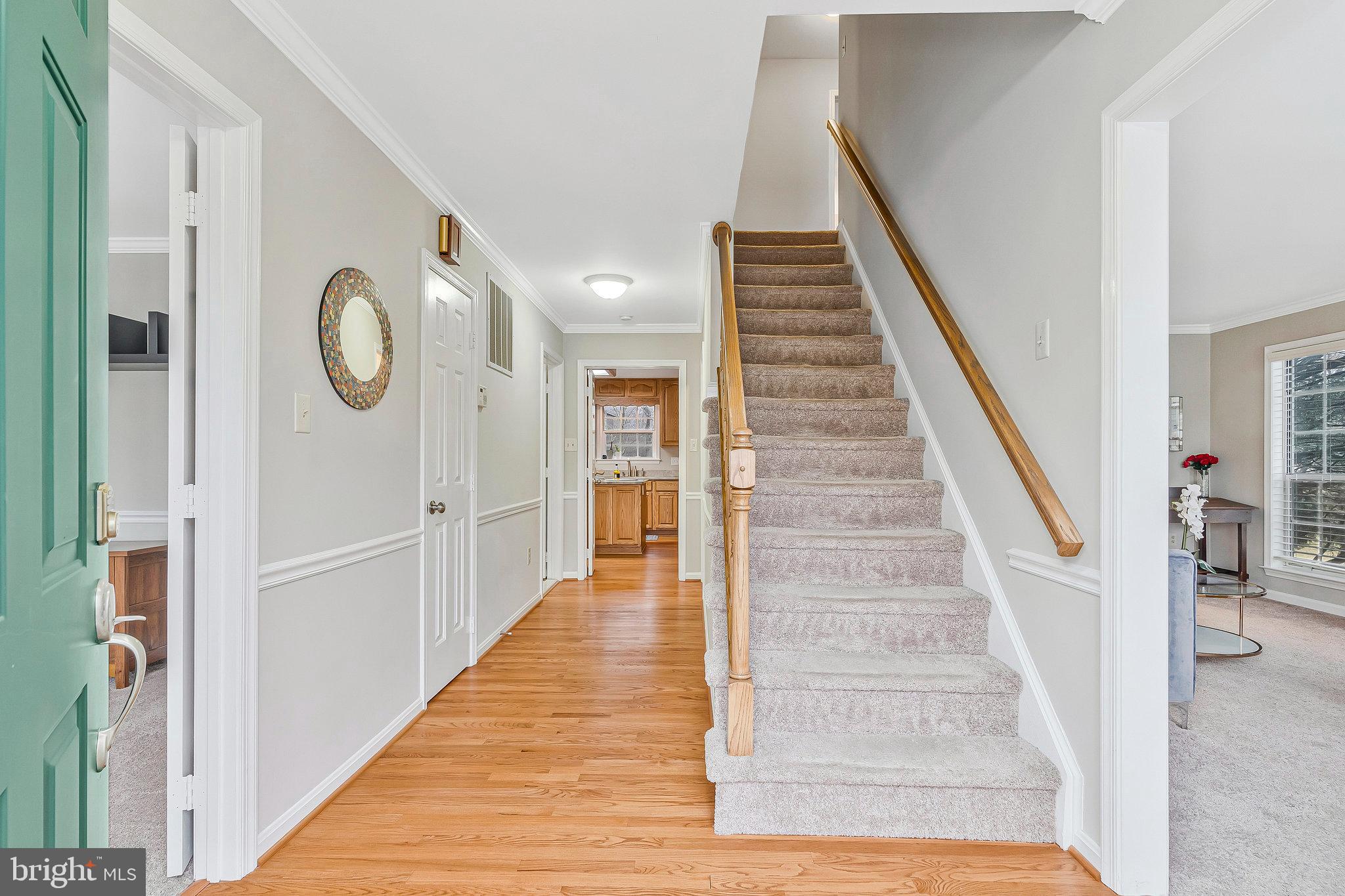 1545 Kingstream Circle Herndon, VA 20170 - Photo 5 of 71 a view of a hallway with wooden floor and staircase
