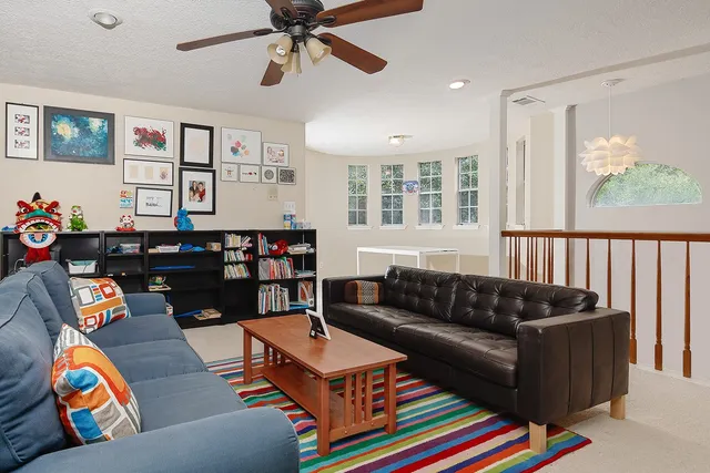 a living room with furniture cabinets and window