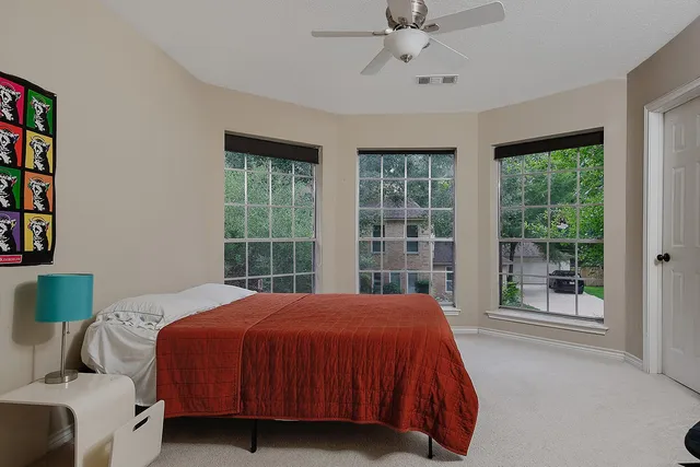 a bedroom with a large bed and a window