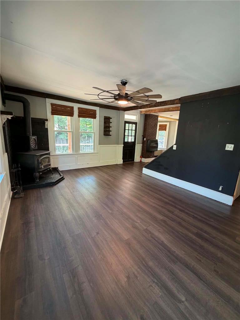 164 Sand Spring Road Cresco, PA 18326 - Photo 34 of 60 A spacious, naturally illuminated room features rich hardwood flooring and a warm, inviting wood-burning stove.
