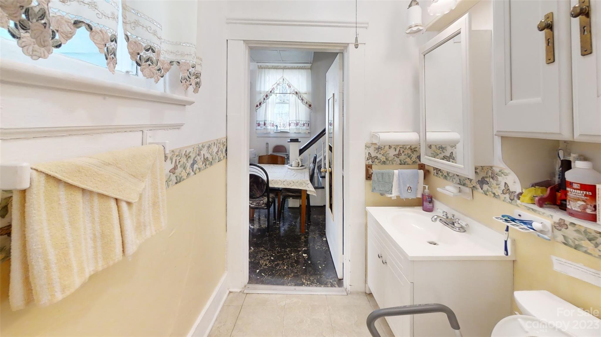 182 Flint Street Asheville, NC 28801 - Photo 11 of 22 a bathroom with a sink vanity and mirror