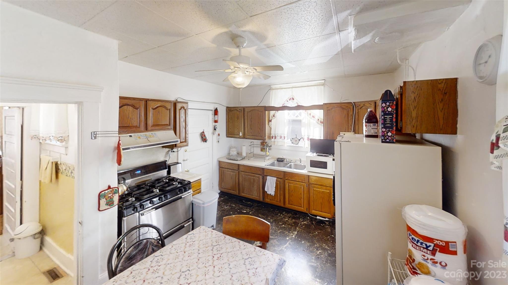 182 Flint Street Asheville, NC 28801 - Photo 14 of 22 a kitchen with stainless steel appliances granite countertop a sink a stove a refrigerator cabinets and living room view