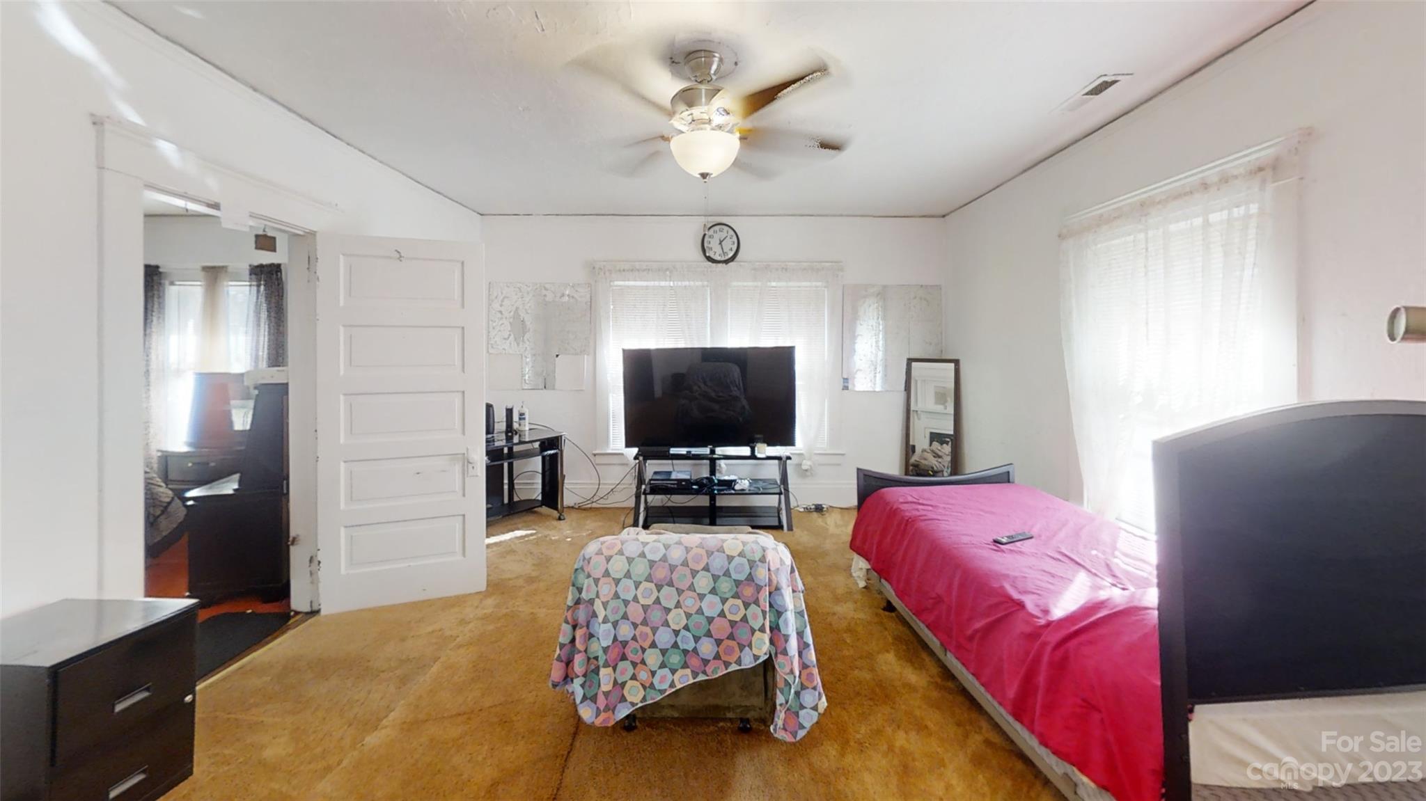 182 Flint Street Asheville, NC 28801 - Photo 16 of 22 a bedroom with a bed and a flat screen tv
