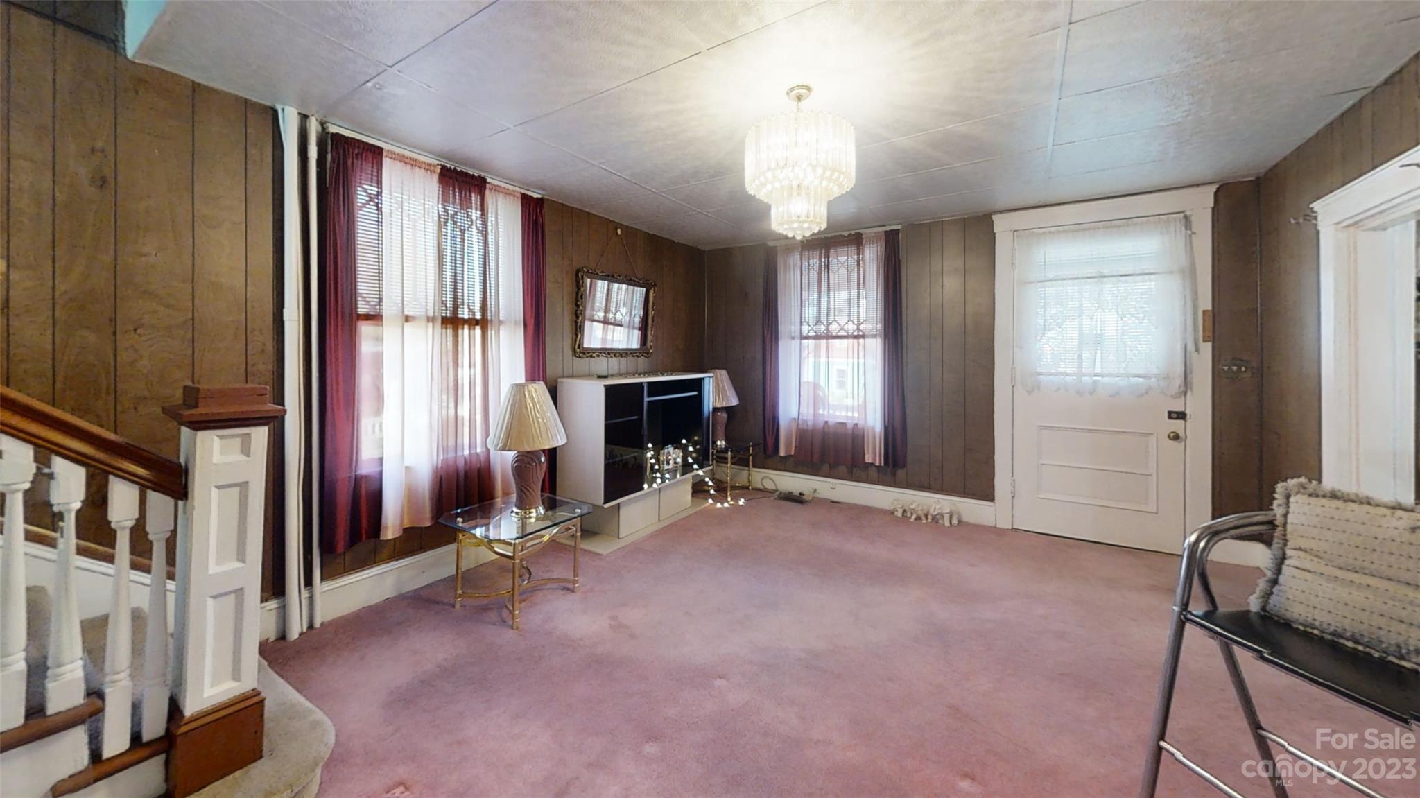 182 Flint Street Asheville, NC 28801 - Photo 7 of 22 a view of a livingroom with a fireplace and windows