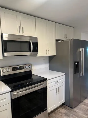 a kitchen with a stove and a microwave