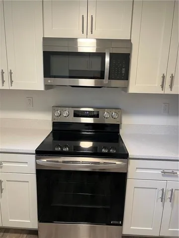 a stove top oven sitting inside of a kitchen