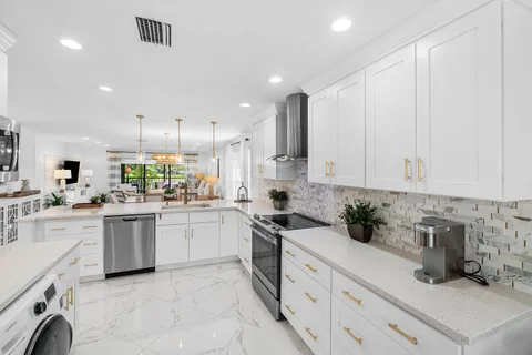 a kitchen with cabinets and appliances