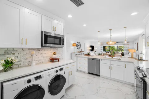 a kitchen with refrigerator a sink and cabinets