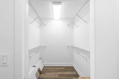 a spacious bathroom with a tub shower and mirror