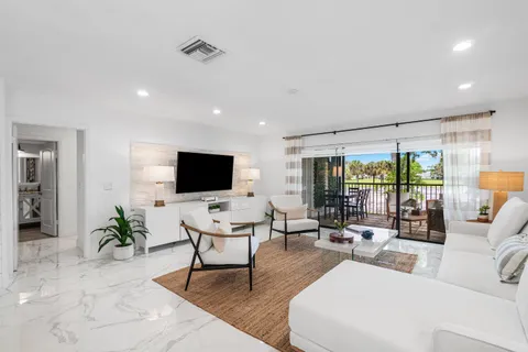 a living room with furniture wooden floor and a flat screen tv