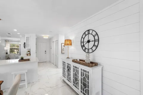 a balcony with furniture and floor to ceiling window