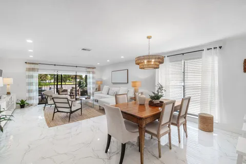 a dining room with furniture window and outside view