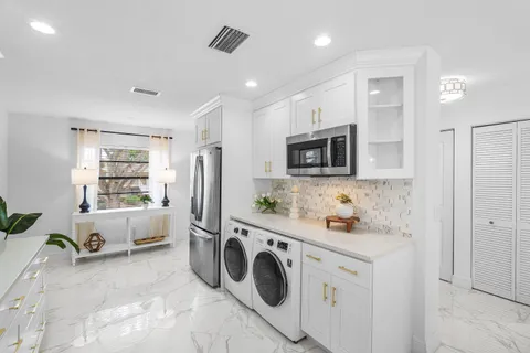 a kitchen with kitchen island granite countertop lots of counter top space sink and cabinets