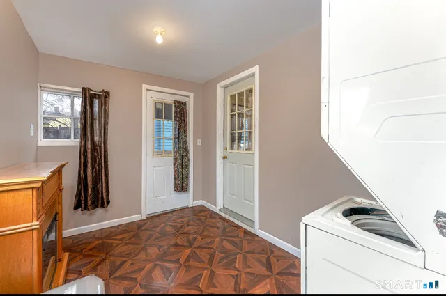 a room with a bed and a refrigerator