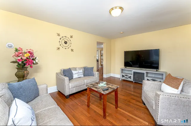 a living room with furniture and a flat screen tv